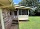 Home's exterior featuring a screened-in porch with access from the backyard at 1046 Waterside Se Dr, Conyers, GA 30013