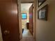 Hallway view leading to a bathroom with a window and light-colored tile at 1046 Waterside Se Dr, Conyers, GA 30013