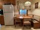 Charming kitchen with built in bench seating, table and bright lighting at 1046 Waterside Se Dr, Conyers, GA 30013