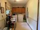 Functional laundry room equipped with a washer, dryer, and storage cabinets at 1046 Waterside Se Dr, Conyers, GA 30013