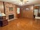 Cozy living room featuring a brick fireplace and classic wood paneled walls at 1046 Waterside Se Dr, Conyers, GA 30013