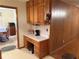 Built in desk and office area in the kitchen with cabinets and wallpaper at 1046 Waterside Se Dr, Conyers, GA 30013