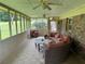 Relaxing screened porch with comfortable seating, ceiling fans, and a view of the outdoors at 1046 Waterside Se Dr, Conyers, GA 30013