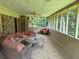Relaxing screened porch with comfortable seating, ceiling fans, and a view of the outdoors at 1046 Waterside Se Dr, Conyers, GA 30013