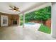 Inviting backyard patio with a fireplace, ceiling fan, and a beautiful pool at 123 Meridian Dr, Woodstock, GA 30188