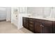 Bathroom features double vanity with dark wood cabinets and tiled floors at 123 Meridian Dr, Woodstock, GA 30188