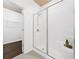 Modern bathroom featuring a glass-enclosed shower with white and silver fixtures and neutral tile flooring at 123 Meridian Dr, Woodstock, GA 30188