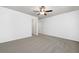 Spacious bedroom with neutral carpet, white walls, ceiling fan, and ensuite bathroom at 123 Meridian Dr, Woodstock, GA 30188