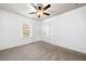 Bright bedroom features neutral carpet, white walls, ceiling fan, and closet at 123 Meridian Dr, Woodstock, GA 30188