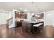Modern kitchen with an island, granite countertops, stainless appliances and dark wood cabinetry at 123 Meridian Dr, Woodstock, GA 30188