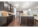 Gourmet kitchen with stainless steel appliances, granite countertops, and dark wood cabinetry at 123 Meridian Dr, Woodstock, GA 30188