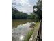 Scenic lake reflecting the sky, framed by lush greenery along the banks for a tranquil view at 123 Meridian Dr, Woodstock, GA 30188