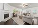 Cozy living room with a fireplace, large windows, and comfortable seating at 123 Meridian Dr, Woodstock, GA 30188