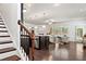 Bright, open-concept living space featuring hardwood floors, a modern kitchen, and comfortable seating area at 123 Meridian Dr, Woodstock, GA 30188