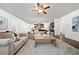 Open concept living space with connecting kitchen, neutral sofas, ceiling fan, and large rug at 123 Meridian Dr, Woodstock, GA 30188