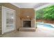 Outdoor fireplace on the covered patio near door and pool at 123 Meridian Dr, Woodstock, GA 30188