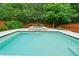 Beautiful in-ground swimming pool and spa surrounded by a privacy fence at 123 Meridian Dr, Woodstock, GA 30188