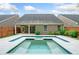 Beautiful backyard pool with elegant tiling and a covered patio, perfect for relaxing and entertaining outdoors at 123 Meridian Dr, Woodstock, GA 30188
