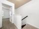 Carpeted stairs with wood railing lead to a light-filled landing and doorway at 123 Meridian Dr, Woodstock, GA 30188
