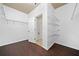 Spacious walk-in closet with dark wood-look flooring, white walls, and wire shelving for optimal storage at 123 Meridian Dr, Woodstock, GA 30188