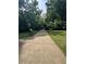 Paved walking path leading through a green space, providing a serene environment for outdoor activities at 123 Meridian Dr, Woodstock, GA 30188
