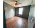 Bedroom with wood look laminate flooring, a ceiling fan and a standard window at 263 Gulfport Ct, Hampton, GA 30228