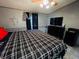This bedroom features a large bed, TV, dresser and window providing natural light at 263 Gulfport Ct, Hampton, GA 30228