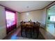 Bright dining room with a cozy table set for six, and natural light at 263 Gulfport Ct, Hampton, GA 30228