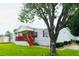 Charming manufactured home boasts a welcoming red porch and well-maintained landscaping at 263 Gulfport Ct, Hampton, GA 30228