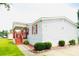 Manufactured home featuring a covered front porch, tidy landscaping, and paved driveway at 263 Gulfport Ct, Hampton, GA 30228