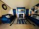 A cozy living room features comfy blue sofas, fireplace, and patterned rug at 263 Gulfport Ct, Hampton, GA 30228