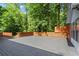 Spacious back deck with horizontal wood railing overlooking lush greenery at 4212 Burns Heritage Ne Trl, Roswell, GA 30075