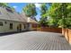 Expansive wooden back deck featuring backyard views and access to the home's interior at 4212 Burns Heritage Ne Trl, Roswell, GA 30075