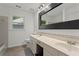 Bright bathroom features a double vanity, window, and tile floor at 4212 Burns Heritage Ne Trl, Roswell, GA 30075