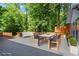 Stained wooden deck includes a dining set, lounge seating, and lush landscaping surrounding the home at 4212 Burns Heritage Ne Trl, Roswell, GA 30075