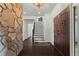 Grand foyer with a stone accent wall, dark hardwood floors, and a staircase at 4212 Burns Heritage Ne Trl, Roswell, GA 30075