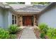 Inviting front entrance with stone surround and double wooden doors, surrounded by lush landscaping at 4212 Burns Heritage Ne Trl, Roswell, GA 30075