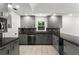 Updated kitchen featuring modern gray cabinets, dark countertops, and stainless steel appliances at 4212 Burns Heritage Ne Trl, Roswell, GA 30075