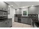 Modern kitchen with gray cabinetry, granite countertops, and stainless steel appliances at 4212 Burns Heritage Ne Trl, Roswell, GA 30075