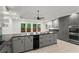 Well-lit kitchen featuring gray cabinets, stainless steel appliances, and granite countertops at 4212 Burns Heritage Ne Trl, Roswell, GA 30075