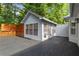 A gray home featuring a spacious deck and a sunroom with an air conditioner at 4212 Burns Heritage Ne Trl, Roswell, GA 30075