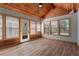 Bright sunroom featuring many windows, wood floors, and a vaulted wood ceiling at 4212 Burns Heritage Ne Trl, Roswell, GA 30075