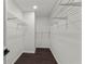 Spacious walk-in closet features wire shelving and wood-look flooring for organized storage and easy maintenance at 4212 Burns Heritage Ne Trl, Roswell, GA 30075
