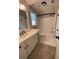 Bathroom features a single sink vanity and shower-tub combo at 1915 Habersham Trce, Cumming, GA 30041
