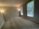 Spacious bedroom with soft carpeting, two windows, and neutral wall paint at 1915 Habersham Trce, Cumming, GA 30041