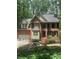 Charming brick home featuring a manicured front yard and an attached two car garage at 1915 Habersham Trce, Cumming, GA 30041
