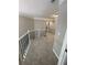 Hallway featuring neutral walls, carpet flooring, and iron railing, providing an elegant transition between rooms at 1915 Habersham Trce, Cumming, GA 30041