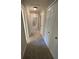 Hallway with soft carpet and several closets and leads to various rooms at 1915 Habersham Trce, Cumming, GA 30041