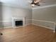Cozy living room features hardwood floors, a fireplace, and ample natural light at 1915 Habersham Trce, Cumming, GA 30041