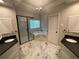 Luxurious bathroom featuring dual vanities, a glass-enclosed shower, and a soaking tub at 1915 Habersham Trce, Cumming, GA 30041